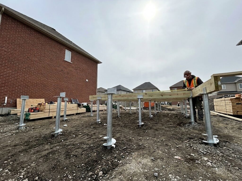 Home addition foundation with helical screw piles