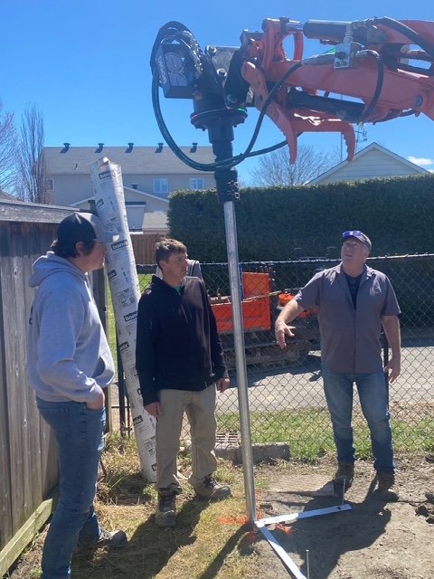 A&Z crew installing helical screw pile in Ottawa backyard