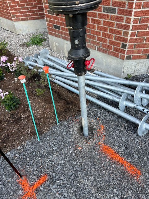 Helical screw piles with blades ready for installation